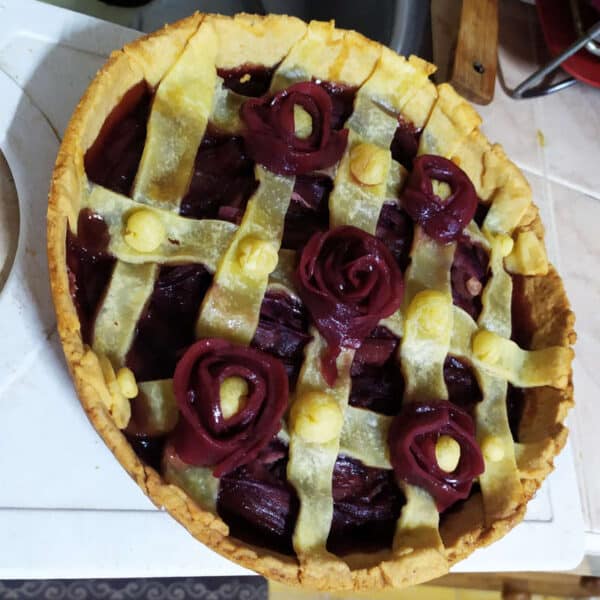 pear pie made with pears in wine and decorated with flowers made from pear slices